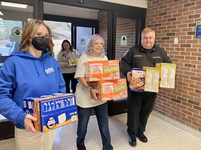 People stocking the Eastern Campus food pantry